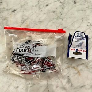 A bag of pin holders and post office tape gun bundles